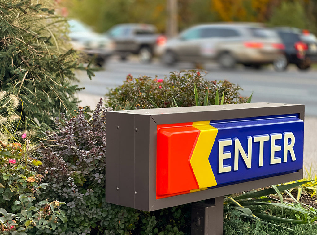 Enter sign with sprinkle road in background