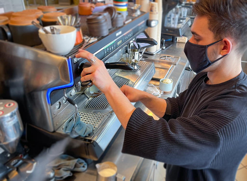 Barista at espresso machine
