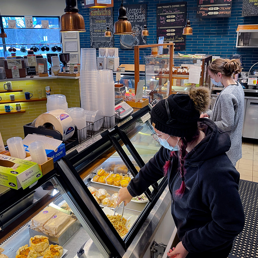 Staff serving from deli case